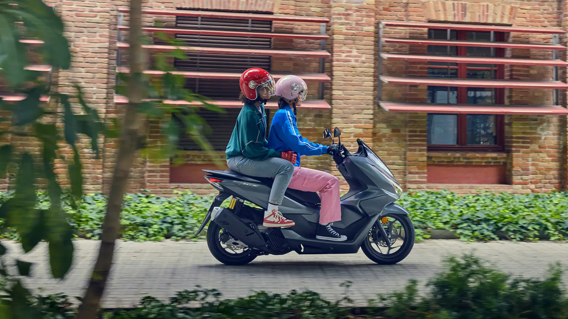 Vue latérale du Honda PCX125 sur route urbaine